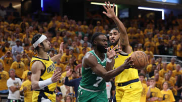 May 25, 2024; Indianapolis, Indiana, USA; Boston Celtics guard Jaylen Brown (7) passes the ball against Indiana Pacers guard Andrew Nembhard (left) and forward Obi Toppin (right) during the fourth quarter of game three of the eastern conference finals in the 2024 NBA playoffs at Gainbridge Fieldhouse. Mandatory Credit: Trevor Ruszkowski-USA TODAY Sports