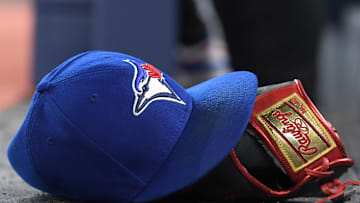 A baseball cap and glove sit on the Toronto Blue Jays dugout steps as they host the Seattle Mariners in their home opener at Rogers Centre in Toronto on April 8, 2024.