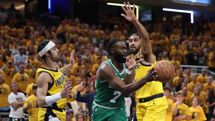 May 25, 2024; Indianapolis, Indiana, USA; Boston Celtics guard Jaylen Brown (7) passes the ball against Indiana Pacers guard Andrew Nembhard (left) and forward Obi Toppin (right) during the fourth quarter of game three of the eastern conference finals in the 2024 NBA playoffs at Gainbridge Fieldhouse. Mandatory Credit: Trevor Ruszkowski-USA TODAY Sports