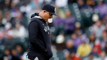May 25, 2025; Denver, Colorado, USA; New York Yankees manager Aaron Boone (17) walks to the dugout after making a pitching change in the sixth inning against the Colorado Rockies at Coors Field. 