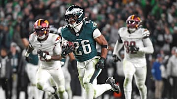 Saquon Barkley runs past Washington Commanders defenders on his way to a 39-yard touchdown in Week 11.