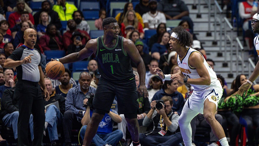 Nov 17, 2023; New Orleans, Louisiana, USA; New Orleans Pelicans forward Zion Williamson (1) dribbles against Denver Nuggets forward Zeke Nnaji (22) during the first half at the Smoothie King Center. Mandatory Credit: Stephen Lew-Imagn Images Nov 17, 2023; New Orleans, Louisiana, USA; New Orleans Pelicans forward Zion Williamson (1) dribbles against Denver Nuggets forward Zeke Nnaji (22) during the first half at the Smoothie King Center. Mandatory Credit: Stephen Lew-Imagn Images