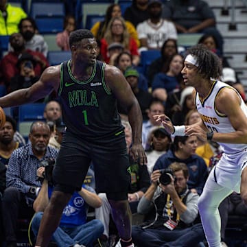 Nov 17, 2023; New Orleans, Louisiana, USA;  New Orleans Pelicans forward Zion Williamson (1) dribbles against Denver Nuggets forward Zeke Nnaji (22) during the first half at the Smoothie King Center. Mandatory Credit: Stephen Lew-Imagn Images