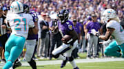 Sep 18, 2022; Baltimore, Maryland, USA; Baltimore Ravens  quarterback Lamar Jackson (8) gains yards in the first quarter against the Miami Dolphins at M&T Bank Stadium. Mandatory Credit: Mitch Stringer-Imagn Images