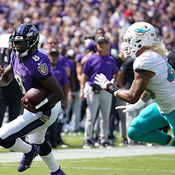 Sep 18, 2022; Baltimore, Maryland, USA; Baltimore Ravens  quarterback Lamar Jackson (8) gains yards in the first quarter against the Miami Dolphins at M&T Bank Stadium. Mandatory Credit: Mitch Stringer-Imagn Images