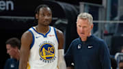October 20, 2023; San Francisco, California, USA; Golden State Warriors head coach Steve Kerr (right) talks to forward Jonathan Kuminga (00) during the third quarter against the San Antonio Spurs at Chase Center. Mandatory Credit: Kyle Terada-Imagn Images