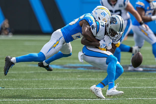 Los Angeles Chargers cornerback Asante Samuel Jr. (26) tackles Carolina Panthers defensive end LaBryan Ray