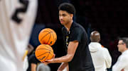 Mar 19, 2025; Wichita, KS, USA; Missouri Tigers center Trent Burns (7) attempts to balance basketball as a drill during a practice session at Intrust Bank Arena.