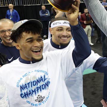 Penn State wrestling coach Cael Sanderson celebrates with Carter Starocci after the Nittany Lions won the team title at the 2024 NCAA Wrestling Championships.