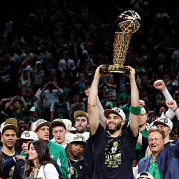 Jun 17, 2024; Boston, Massachusetts, USA; Boston Celtics forward Jayson Tatum (0) celebrates with the Larry O’Brian Trophy after beating the Dallas Mavericks in game five of the 2024 NBA Finals to win the NBA Championship at TD Garden. Mandatory Credit: Peter Casey-USA TODAY Sports