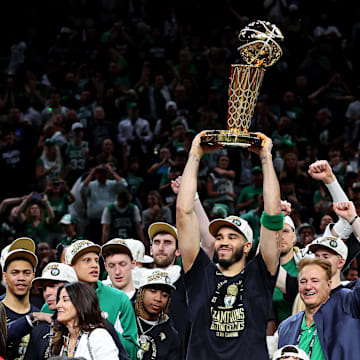 Jun 17, 2024; Boston, Massachusetts, USA; Boston Celtics forward Jayson Tatum (0) celebrates with the Larry O’Brien Trophy after beating the Dallas Mavericks in game five of the 2024 NBA Finals to win the NBA Championship at TD Garden. Mandatory Credit: Peter Casey-Imagn Images