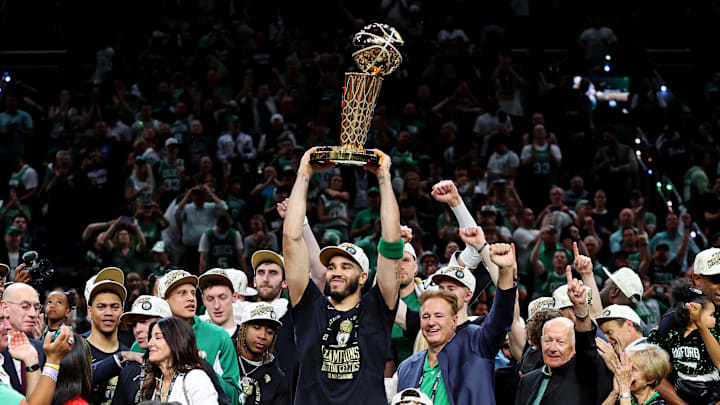 Jun 17, 2024; Boston, Massachusetts, USA; Boston Celtics forward Jayson Tatum (0) celebrates with the Larry O’Brien Trophy after beating the Dallas Mavericks in game five of the 2024 NBA Finals to win the NBA Championship at TD Garden. Mandatory Credit: Peter Casey-Imagn Images