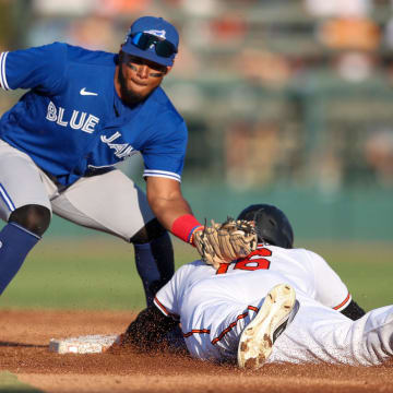Mar 16, 2023; Sarasota, Florida, USA;  Baltimore Orioles left fielder Franchy Cordero (16) steals second base from Toronto Blue Jays second baseman Leo Jimenez (49) in the second inning during spring training at Ed Smith Stadium.