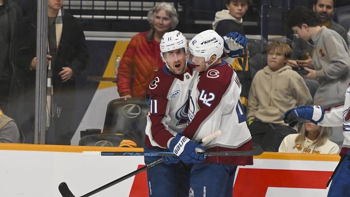Dec 9, 2025; Nashville, Tennessee, USA;  Colorado Avalanche center Brock Nelson (11) celebrates his goal with defenseman Josh Manson (42) against the Nashville Predators during the first period at Bridgestone Arena. Mandatory Credit: Steve Roberts-Imagn Images