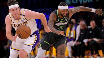 Los Angeles Lakers guard Austin Reaves (15) drives past Minnesota Timberwolves guard Nickeil Alexander-Walker (9) in the first half at Crypto.com Arena.