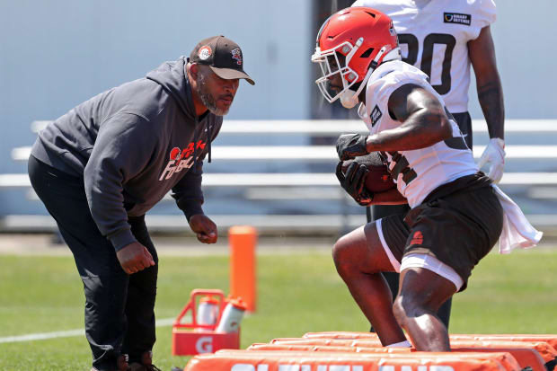 Running back side steps over bags in practice.