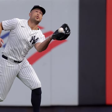 Aug 11, 2025; Bronx, New York, USA; New York Yankees right fielder Giancarlo Stanton (27) catches a fly ball by Minnesota Twins designated hitter Luke Keaschall (not pictured) during the fourth inning at Yankee Stadium. Mandatory Credit: Brad Penner-Imagn Images