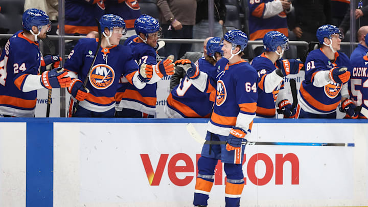 Apr 9, 2026; Elmont, New York, USA;  New York Islanders center Calum Ritchie (64) celebrates with teammates after scoring a goal in the third period against the Toronto Maple Leafs at UBS Arena. Mandatory Credit: Wendell Cruz-Imagn Images