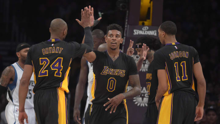 Nov 28, 2014; Los Angeles, CA, USA; Los Angeles Lakers guards Kobe Bryant (24) and Nick Young (0) and forward Wesley Johnson (11) react against the Minnesota Timberwolves at Staples Center. The Timberwolves defeated the Lakers 120-119. Mandatory Credit: Kirby Lee-USA TODAY Sports
