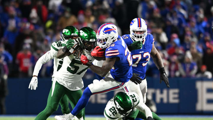 Nov 19, 2023; Orchard Park, NY; Buffalo Bills running back Latavius Murray (28) is tackled by New York Jets safety Tony Adams (22) and linebacker C.J. Mosley (57) in the fourth quarter at Highmark Stadium. 