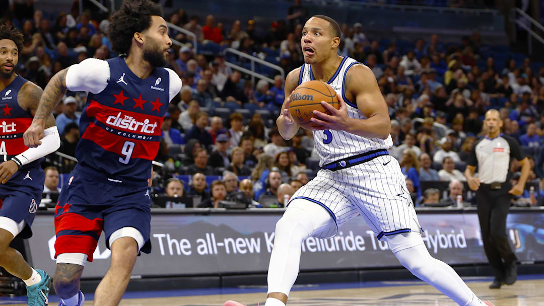 Mar 3, 2026; Orlando, Florida, USA;  Orlando Magic guard Desmond Bane (3) drives to the basket as Washington Wizards forward Justin Champagnie (9) defends in the second half at Kia Center. Mandatory Credit: Russell Lansford-Imagn Images