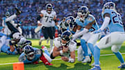 Jacksonville Jaguars quarterback Trevor Lawrence (16) dives in just short of the end zone as Tennessee Titans defensive tackle Jeffery Simmons (98), linebacker Jaylen Harrell (92) and safety Kevin Winston Jr. (23) pursue during the third quarter at Nissan Stadium in Nashville, Tenn., Sunday, Nov. 30, 2025.