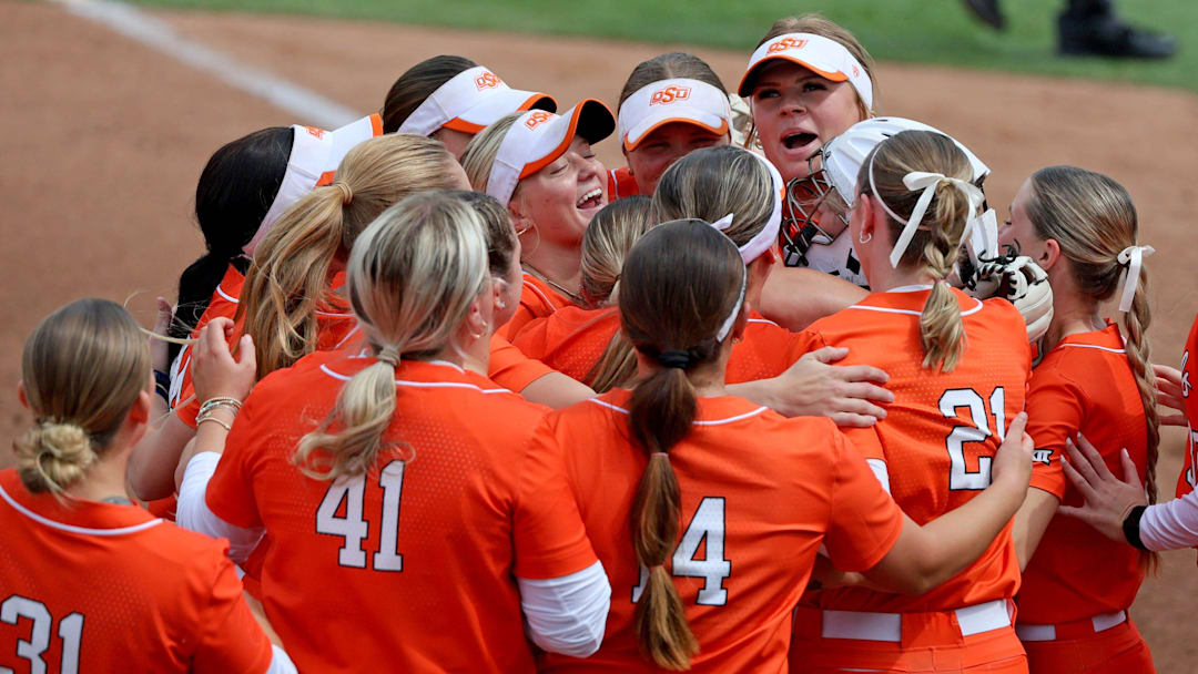 Oklahoma State's Lexi Kilfoyl, top right, celebrates with teammates after a college softball game