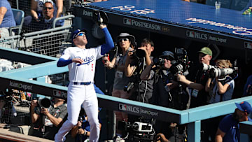 Oct 14, 2024; Los Angeles, California, USA; Los Angeles Dodgers first base Freddie Freeman (5) makes a catch in foul territory against the New York Mets in the third inning during game two of the NLCS for the 2024 MLB Playoffs at Dodger Stadium. 