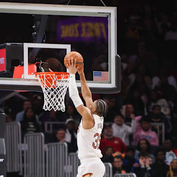 Mar 6, 2024; Atlanta, Georgia, USA; Cleveland Cavaliers forward Isaac Okoro (35) dunks after stealing the ball from Atlanta Hawks forward De'Andre Hunter (12) in the second half at State Farm Arena. Mandatory Credit: Brett Davis-Imagn Images
