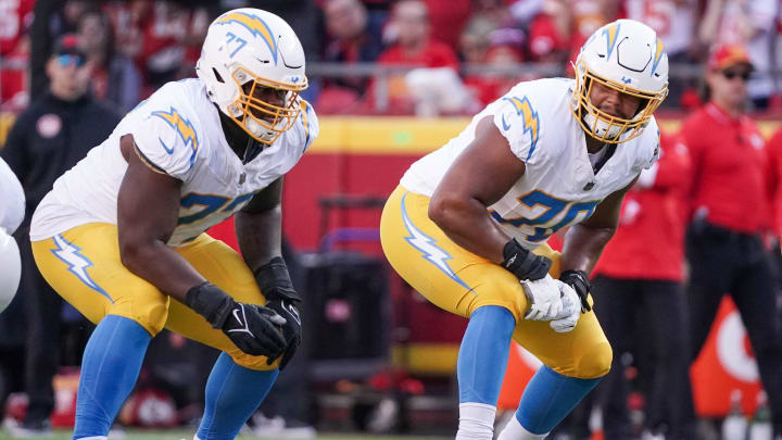 Oct 12, 2023; Kansas City, Missouri, USA; Los Angeles Chargers offensive tackle Rashawn Slater (70) and guard Zion Johnson (77) line up against the Kansas City Chiefs during the game at GEHA Field at Arrowhead Stadium. Mandatory Credit: Denny Medley-USA TODAY Sports