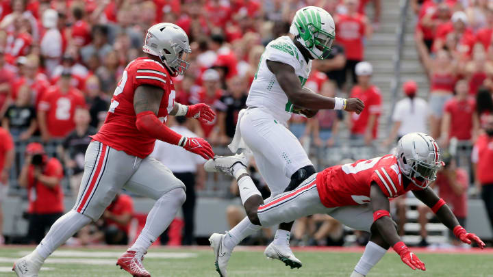 Oregon Ducks quarterback Anthony Brown (13) is pursued by Ohio State Buckeyes defensive tackle Haskell Garrett (92) and Ohio State Buckeyes cornerback Denzel Burke (29) during Saturday's NCAA Division I football game at Ohio Stadium in Columbus on September 11, 2021.

Osu21ore Bjp 753