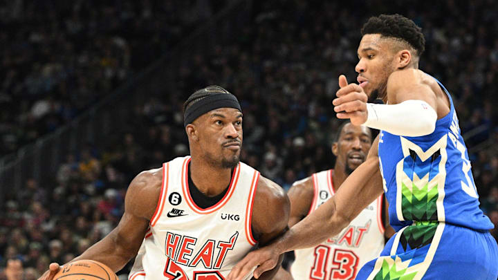 Feb 4, 2023; Milwaukee, Wisconsin, USA; Miami Heat forward Jimmy Butler (22) drives to the basket against Milwaukee Bucks forward Giannis Antetokounmpo (34) in the second half at Fiserv Forum. Mandatory Credit: Michael McLoone-Imagn Images