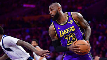 Feb 25, 2025; Los Angeles, California, USA; Los Angeles Lakers forward LeBron James (23) grabs rebound against the Dallas Mavericks during the first half at Crypto.com Arena. Mandatory Credit: Gary A. Vasquez-Imagn Images