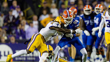Nov 11, 2023; Baton Rouge, Louisiana, USA; LSU Tigers linebacker Harold Perkins Jr. (4) tackles Florida Gators wide receiver Marcus Burke (88) during the second half at Tiger Stadium. Mandatory Credit: Stephen Lew-USA TODAY Sports
