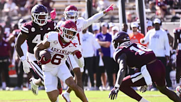 Oct 26, 2024; Starkville, Mississippi, USA; Arkansas Razorbacks wide receiver Isaiah Sategna (6) runs the ball while defended by Mississippi State Bulldogs safety Corey Ellington (10) during the fourth quarter at Davis Wade Stadium at Scott Field. Mandatory Credit: Matt Bush-Imagn Images