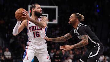 Jan 4, 2025; Brooklyn, New York, USA; Philadelphia 76ers forward Caleb Martin (16) looks to pass as Brooklyn Nets guard D'Angelo Russell (1) defends during the first quarter at Barclays Center. Mandatory Credit: Vincent Carchietta-Imagn Images