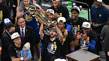 Warriors guard Stephen Curry holds up the Larry O'Brien Trophy after defeating the Celtics in Game six of the 2022 NBA Finals.