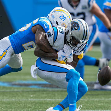 Sep 15, 2024; Charlotte, North Carolina, USA; Los Angeles Chargers cornerback Asante Samuel Jr. (26) tackles Carolina Panthers defensive end LaBryan Ray (93) during the second half at Bank of America Stadium. 