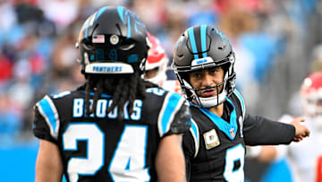Nov 24, 2024; Charlotte, North Carolina, USA;  Carolina Panthers quarterback Bryce Young (9) talks to running back Jonathon Brooks (24) in the fourth quarter at Bank of America Stadium. Mandatory Credit: Bob Donnan-Imagn Images
