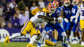 Nov 11, 2023; Baton Rouge, Louisiana, USA; LSU Tigers linebacker Harold Perkins Jr. (4) tackles Florida Gators wide receiver Marcus Burke (88) during the second half at Tiger Stadium. Mandatory Credit: Stephen Lew-USA TODAY Sports