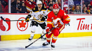 Dec 17, 2024; Calgary, Alberta, CAN; Calgary Flames defenseman Rasmus Andersson (4) controls the puck against the Boston Bruins during the first period at Scotiabank Saddledome. Mandatory Credit: Sergei Belski-Imagn Images