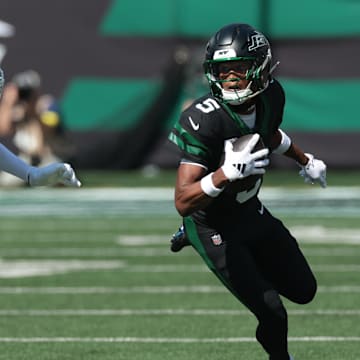 Oct 5, 2025; East Rutherford, New Jersey, USA; New York Jets wide receiver Garrett Wilson (5) turns up field after the catch as Dallas Cowboys cornerback Trevon Diggs (7) defends during the first half at MetLife Stadium. Mandatory Credit: Vincent Carchietta-Imagn Images