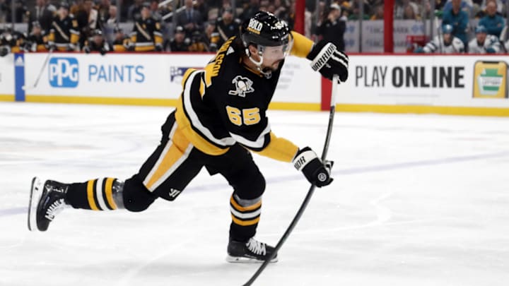 Mar 14, 2024; Pittsburgh, Pennsylvania, USA; Pittsburgh Penguins defenseman Erik Karlsson (65) shoots the puck against the San Jose Sharks during the first period at PPG Paints Arena. Mandatory Credit: Charles LeClaire-Imagn Images