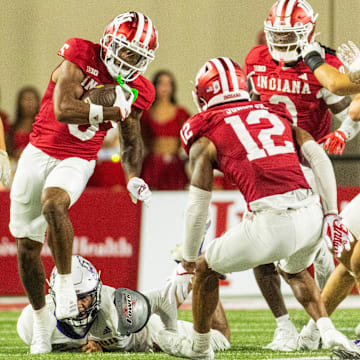 Sep 6, 2024; Bloomington, Indiana, USA;  Indiana Hoosiers wide receiver Ke'Shawn Williams (5) runs the ball while Western Illinois Leathernecks defensive lineman Jalen Riven (5) defends in the second half at Memorial Stadium.