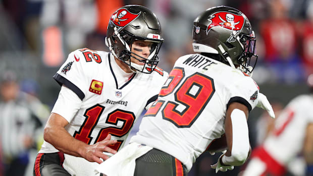 Tampa Bay Buccaneers quarterback Tom Brady hands off to running back Rachaad White.