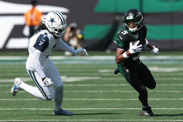 New York Jets wide receiver Garrett Wilson turns upfield after the catch as Dallas Cowboys cornerback Trevon Diggs defends.