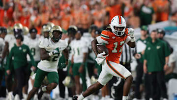 Sep 13, 2025; Miami Gardens, Florida, USA; Miami Hurricanes wide receiver Tony Johnson (17) carries the football against the South Florida Bulls during the fourth quarter at Hard Rock Stadium. Mandatory Credit: Sam Navarro-Imagn Images
