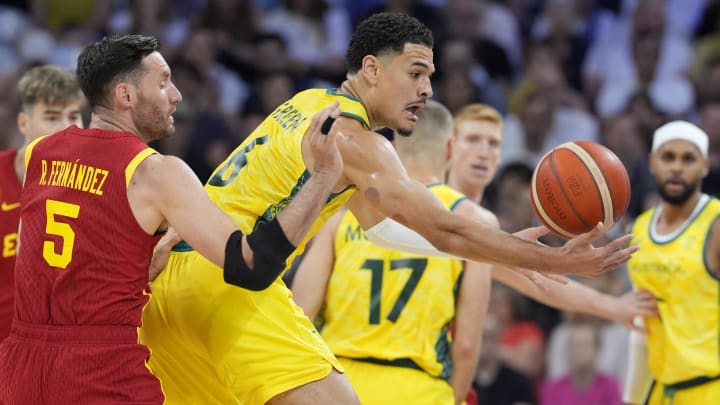 Jul 27, 2024; Villeneuve-d'Ascq, France; Spain small forward Rudy Fernandez (5) and Australia small forward Josh Green (6) battle for the ball  in men's Group A play during the Paris 2024 Olympic Summer Games at Stade Pierre-Mauroy.