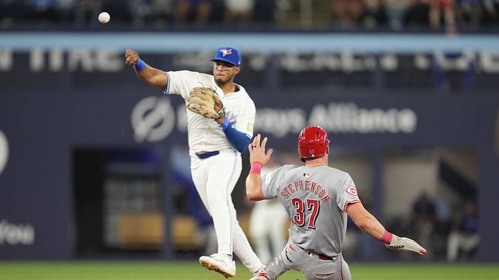 Aug 20, 2024; Toronto, Ontario, CAN; Toronto Blue Jays shortstop Leo Jimenez (49) throws to first base after getting Cincinnati Reds catcher Tyler Stephenson (37) out at second base during the eighth inning at Rogers Centre. Mandatory Credit: John E. Sokolowski-USA TODAY Sports