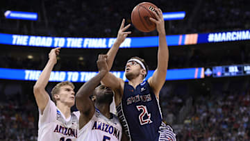 March 18, 2017; Salt Lake City, UT, USA; Saint Mary's Gaels forward Calvin Hermanson (24) moves to the basket against Arizona Wildcats forward Lauri Markkanen (10) and guard Kadeem Allen (5) during the second half in the second round of the 2017 NCAA Tournament at Vivint Smart Home Arena. Mandatory Credit: Kelvin Kuo-Imagn Images